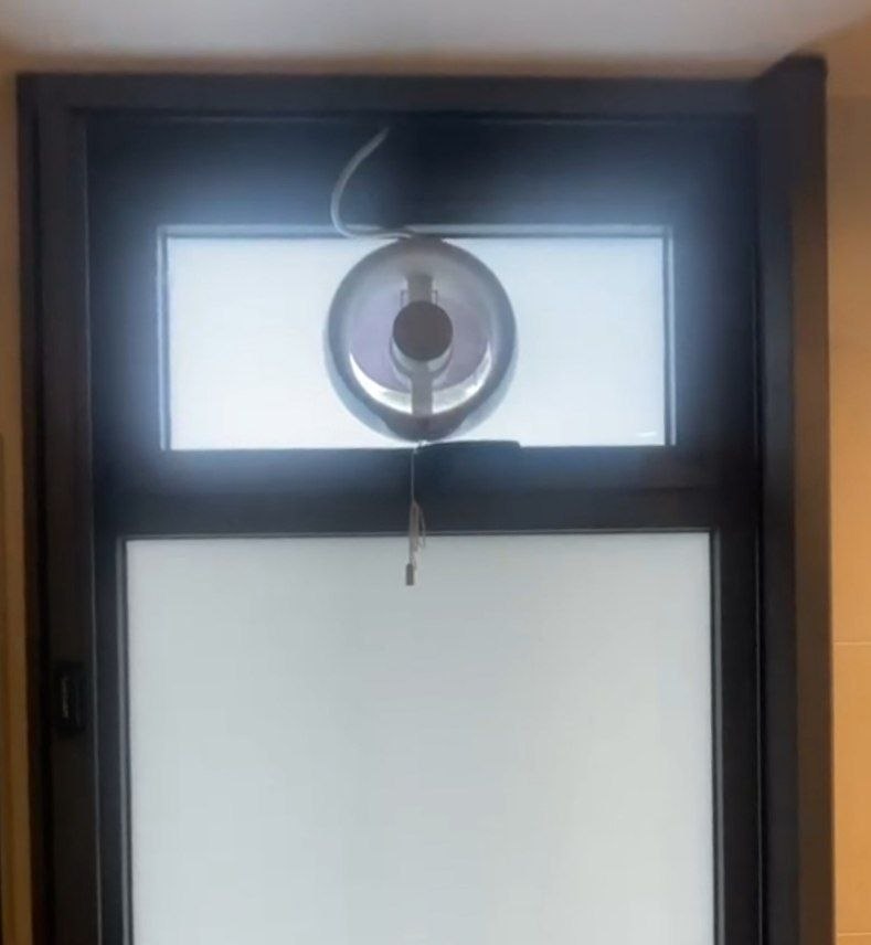 Custom mesh screen installed over bathroom ventilation fan